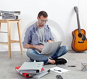 Self-employed man working his budget on computer