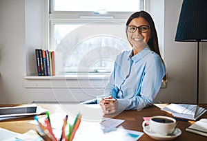 Self employed woman wearing glasses at desk