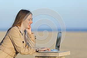 Self employed woman working with a laptop outdoors photo