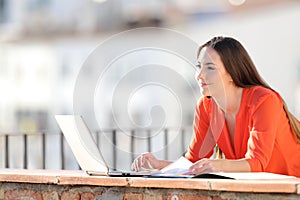 Self employed working in a balcony contemplating views