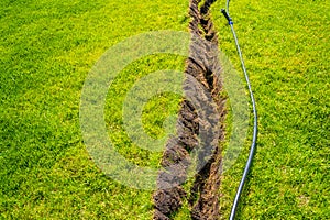 Self-installation of irrigation with a retractable sprinkler in the finished lawn. Laying water pipes with sprayers under the lawn