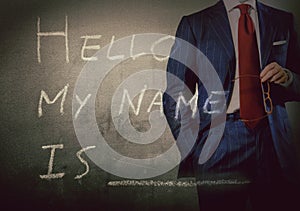 Self Introduction - Hello, My name is ... written on a blackboard with businessman