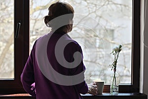 A Self-isolate Woman or Quarantine Looking Out photo