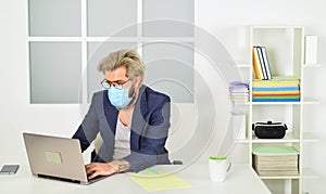 Self isolation top response tactic for managing outbreak of COVID 19. Home office. Man wear medical mask work with