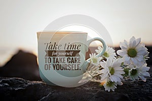 Self love inspirational motivational words - Take time for yourself to take care of yourself. Cup of morning coffee with flowers. photo