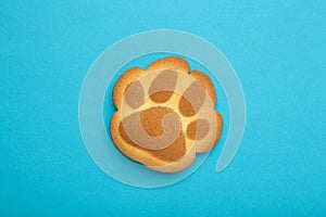 Self made cat paw cookies on blue background