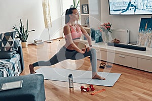 Self-motivated fit young woman in sports clothing