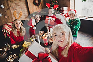 Self-portrait of attractive cheerful family celebrating Eve Noel exchanging gifts surprise at home loft house indoors