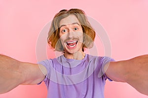 Self-portrait of attractive cheerful guy having fun fooling good mood rest isolated over pink pastel color background