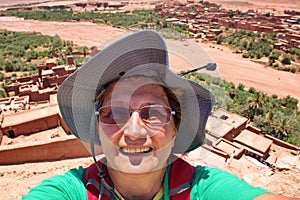 Self portrait of the mature woman over Ait ben Haddou in Morocco