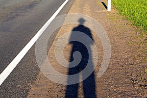 Self-portrait.The shadow man on the road.
