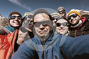 Self Portrait of Team of Mountain Climbers smiling and happy