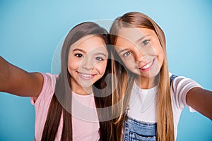 Self-portrait of two people nice-looking cute shine lovable lovely tender cheerful straight-haired pre-teen girls having