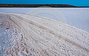 Self-precipitating table salt sodium chloride on the surface of a dried-up reservoir