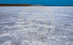 Self-precipitating table salt sodium chloride on the surface of a dried-up reservoir