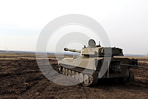Self-propelled artillery large caliber is in the field, rear view