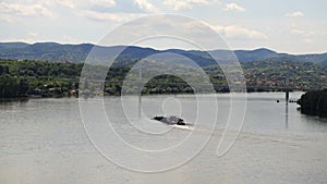 Self propelled barge sailing upstream river Danube