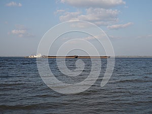 Self-propelled double scow on the river with loose cargo