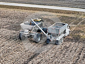 Self propelled spreader being loaded with fertilizer before applying to a field