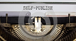 Self-publish symbol. Words `self-publish` typed on retro typewriter. Business and self-publish concept. Beautiful background photo