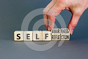 Self reflection awareness symbol. Concept words Self reflection and self awareness on cubes. Beautiful grey background.