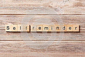 Self reminder word written on wood block. self reminder text on table, concept