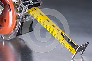 Self-retracting metal tape measure