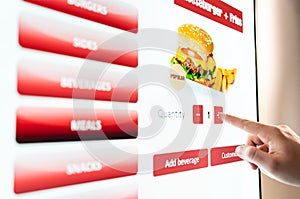 Self service order kiosk and digital menu in fast food burger restaurant. Touch screen in vending machine. photo