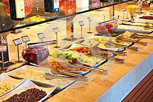 Self service restaurant and barbecue steakhouse with salad table.