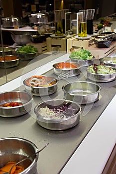 Self service salad bar with a variety of salads