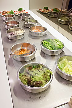 Self service salad bar with a variety of salads