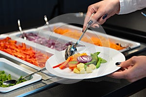 Self service at a salad buffet, catering business vegan food