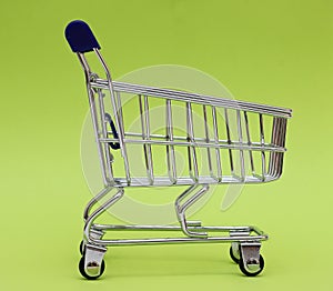 Self-service supermarket full shopping trolley cart on colorful background