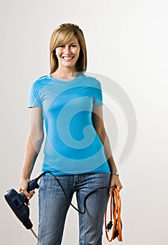 Self-sufficient woman holding drill photo