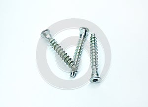 Self-tapping bolts with flat heads on a white background.