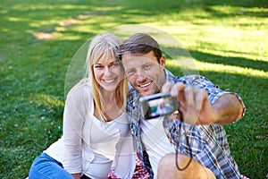 Selfie, camera and couple in a park, love and happiness with marriage and romance with summer or nature. Photograph