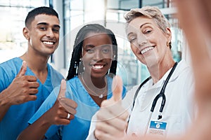 Selfie, doctor and students with thumbs up portrait at hospital for success, diversity and healthcare. Interracial