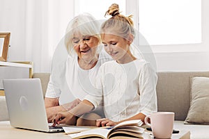 Selfie education video togetherness sofa granddaughter hugging grandmother bonding child smiling call family laptop