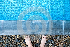 Selfie the feet at the pool side or edge with blue mosaic tiles