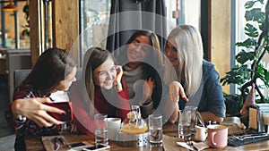 Selfie four women sitting in a cafe