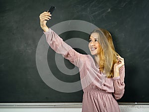 Selfie in front of a blackboard in class