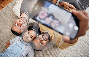 Selfie, gay father and blended family with a girl lying together on the floor of the home for a picture from above. LGBT