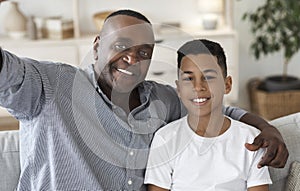 Selfie With Grandfather. Happy black granddad and grandson taking photo together