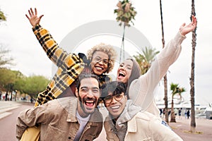 Selfie of Group of young cheerful people looking at the camera outdoors. Happy smiling friends hugging