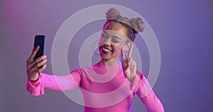 Selfie, hand gesture or happy woman in studio with phone for makeup, photography or fun photoshoot on purple background