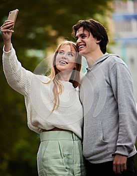 Selfie, happy and couple bonding in the city for memory, travel and on holiday together. Smile, date and woman taking a