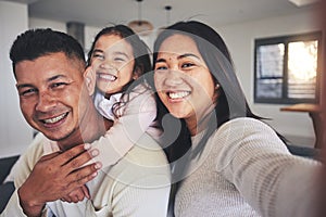 Selfie, happy and portrait of a family with a smile bonding in the living room of their home. Together, love and young