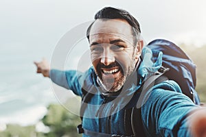 Selfie, hiking and man with nature, fitness and excited with happiness, adventure and travel. Portrait, person and hiker