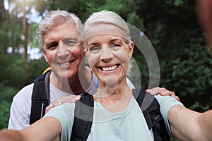 Selfie, hiking and portrait of senior couple with smile on adventure in forest, woods and mountain for exercise. Fitness