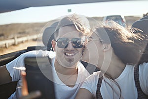 Selfie, kiss and road trip with a real couple driving on the one road for vacation, honeymoon or romance. Love, happy